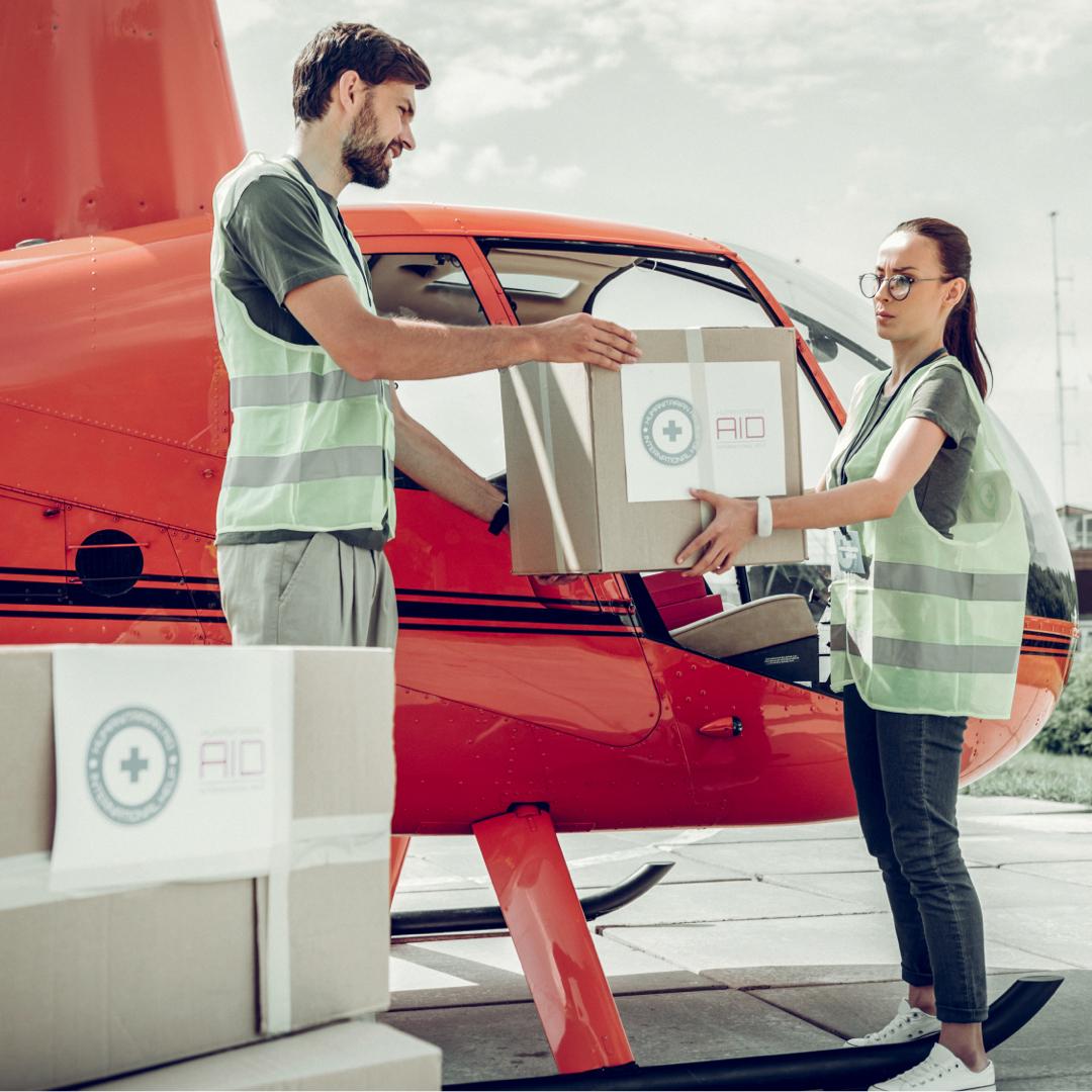 Staff loading medical supplies onto a helicopter